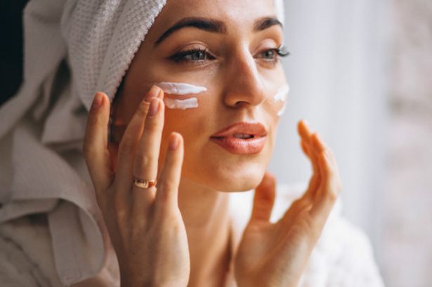 0_woman-applying-face-cream_1303-14312