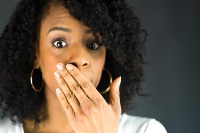 woman-covering-her-mouth-with-one-hand