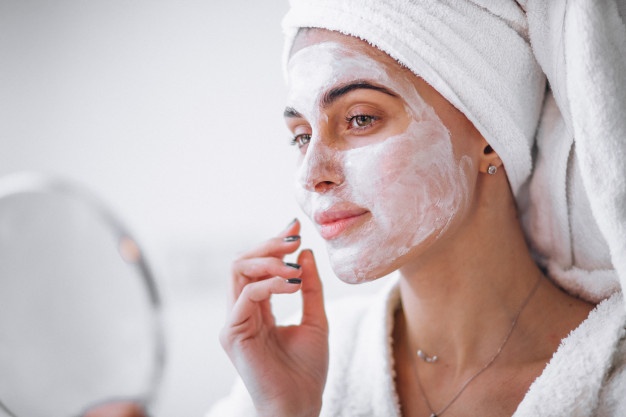 woman-applying-beauty-mask_1303-13043